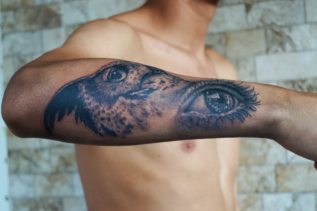 Man Showing Tattoo On Arm. tattooedliverpool.com
